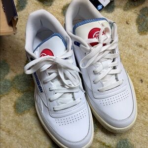 The Pump Reebok White Leather Sneakers with Blue Trim and Red Logos